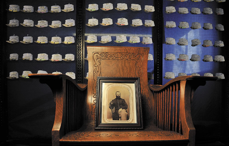 CLINTON SOLDIERS: A photo of Capt. Charles W. Billings sits on a chair at the Brown Memorial Library in front of Union hats representing each of the 250 Clinton men who served in the Civil War. The library will be celebrating the lives of those soldiers with an open house on Tuesday from 4 to 8 p.m.