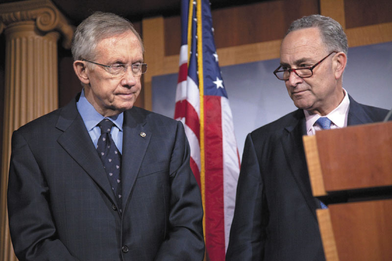 NOT LOOKING ENTHUSED: Senate Majority Leader Harry Reid, D-Nev., left, and Sen. Charles Schumer, D-N.Y., pause during a news conference on Capitol Hill in Washington on Thursday. Congress sent President Barack Obama hard-fought legislation cutting a record $38 billion from federal spending on Thursday, but it was a bill no one claimed to like in its entirety.