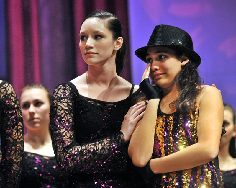 Assistant instructor Megan McQuarrie, 18, comforts Breona Henderson, 13, right, the recipient of the 2011 Brittany LaBrie Scholarship, at the Messalonskee Performing Arts Center in Oakland on Thursday evening.