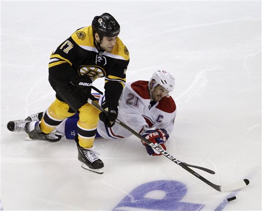 TANGLED UP: Boston Bruins left wing Milan Lucic (17) battles Montreal Canadiens right wing Brian Gionta for the puck during the Canadiens’ 2-0 win in Game 1 of their playoff series Thursday night.