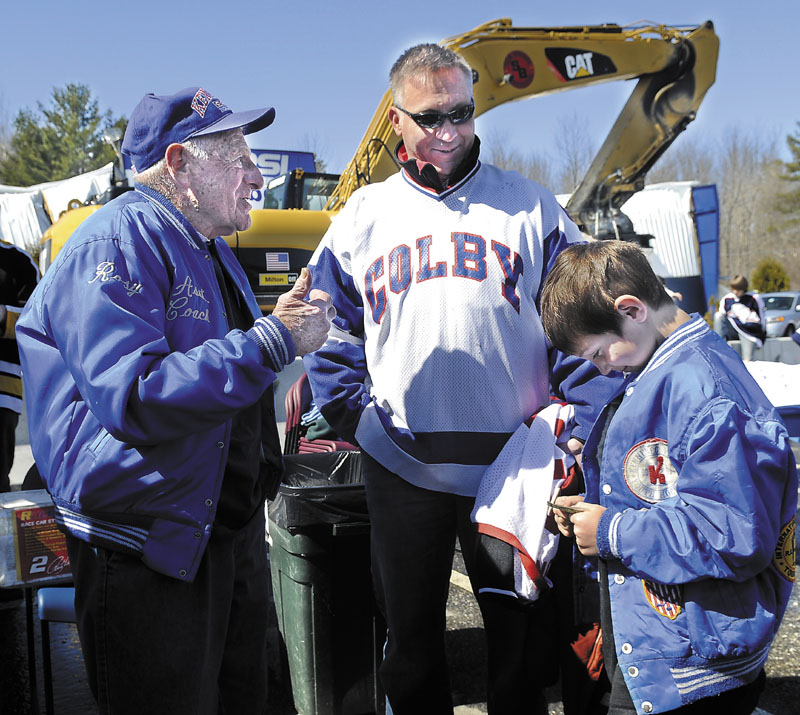 Cody Turner, right, is introduced to Rosy Santerre, left, by Turner's father, Eric, Sunday during a rally to show support for hockey at the Kennebec Ice Arena in Hallowell. In the 1970s, Santerre, a legend in the Maine hockey community, coached the elder Turner, who went on to play at Colby College. Santerre and Peter Prescott own the arena, which collapsed in March. Several hundred people attended the rally.