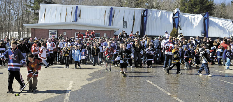 People congregate Sunday outside the Kennebec Ice Arena in Hallowell to show support for youth hockey. Several hundred people attended the event at the rink that collapsed in March.