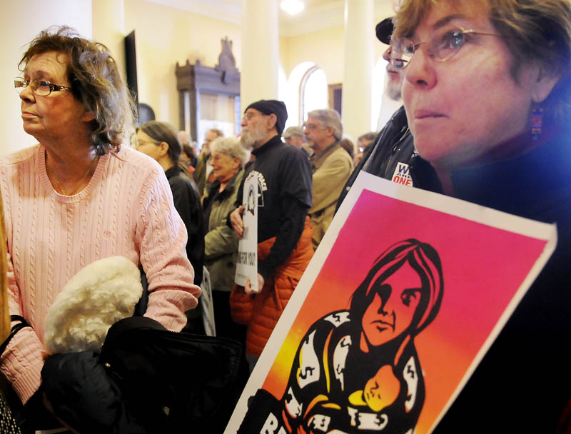 Protesters gather Monday at the State House to object to war funding and removal of murals from the Maine Department of Labor.