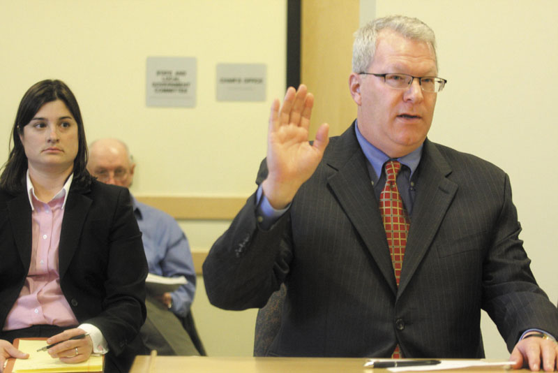 Former Maine Turnpike Authority executive director Paul Violette takes an oath while appearing before the Legislature's Government Oversight Committee at the State House in Augusta on Friday. Violette, with advice from his attorney, repeatedly declined to answer questions from the committee regarding gift card purchases.