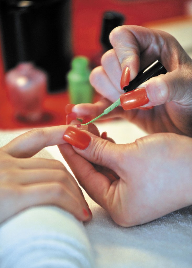 Maila Couture, of Agora Hair Gallery and Day Spa, paints Cheri Thebault's nails during the World of Women's Wellness 2011 sponsored by Inland Hospital at Thomas College in Waterville Saturday.