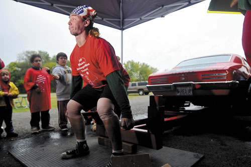 Staff photo by Andy Molloy A TOUGH MAN: James Fuller of Hallowel, attempts to dead lift car at a strongman competition in Augusta. Fuller will be one of aobut 30 contestants to compete in the Central Maine Strongman Competition Saturday at the Augusta Armory.