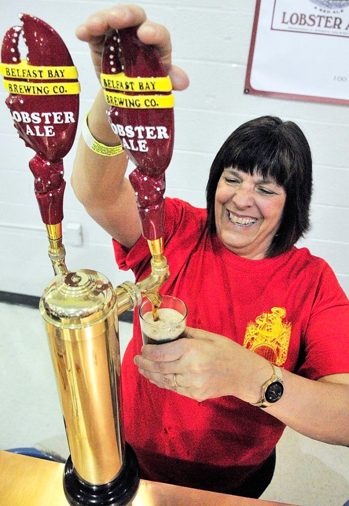 Marietta Crocker pulls a sample of Belfast Bay Brewing Company Lobster Ale at the Third Annual Central Maine Brew Fest on Saturday afternoon in the Augusta State Armory.