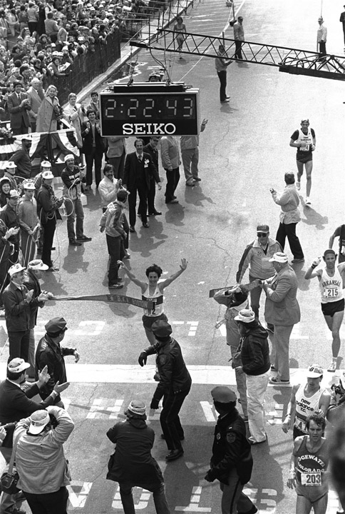 In this April,18, 1983, photo Joan Benoit crosses the finish line to win the Boston Marathon and shatter the world women's mark in 2:22.42. She clipped nearly three minutes off the old mark. The clock in the picture registers the time one second after she broke the tape. Samuelson, now 53, says she'll run in next week's Boston Marathon.