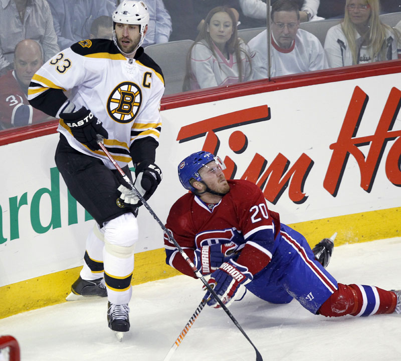 Boston Bruins defenseman Zdeno Chara, left, checks Montreal Canadiens defenseman James Wisniewski during the first period in Game 3 of their Eastern Conference first-round series Monday night in Montreal. Chara, who missed Game 2 on Saturday with what the team said was a case of dehydration, helped the Bruins win 4-2. The Canadiens lead the best-of-seven series 2-1.