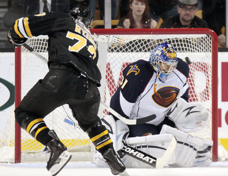 ONE-ON-ONE: Boston Bruins winger Michael Ryder, left, scores the go-ahead goal on a penalty shot against Atlanta Thrashers goalie Ondrej Pavelec during the third period Saturda in Boston. The Bruins won 3-2 and clinched the Northeast Division title.