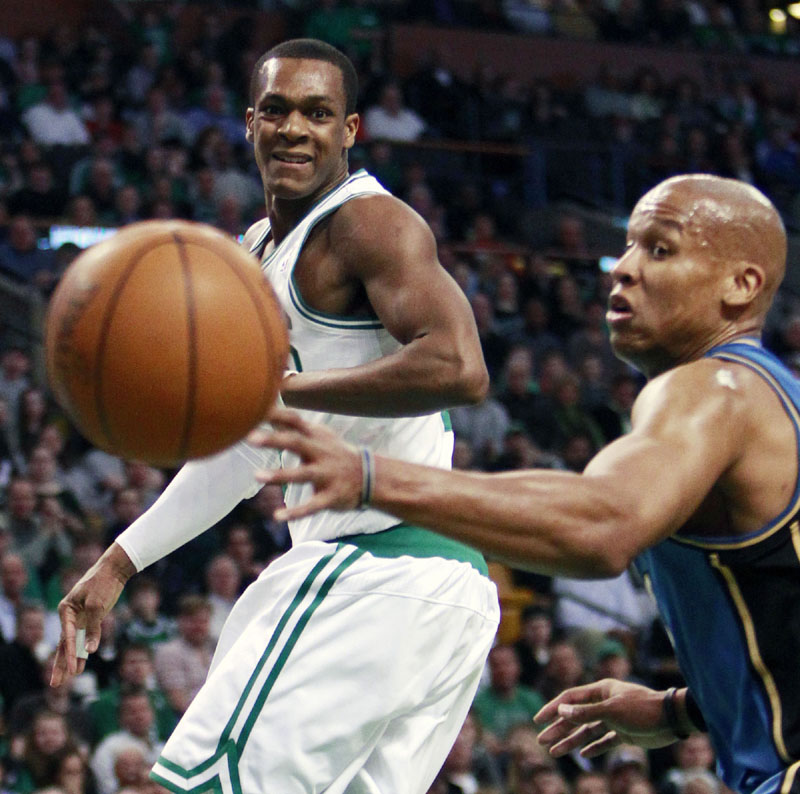PASSING FANCY: Boston Celtics point guard Rajon Rondo, left, passes into the post while Washington Wizards guard Maurice Evans looks on in the first quarter Friday night in Boston. Rajon Rondo had 20 points and 14 assists to lead the Celtics to a 104-88 victory.