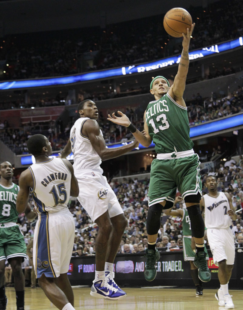 GOING IN: Boston Celtics guard Delonte West, right, shoots past Washington Wizards defenders during the first half of a 95-94 overtime loss Monday night in Washington. The Celtics sat four starters as the playoffs draw close.