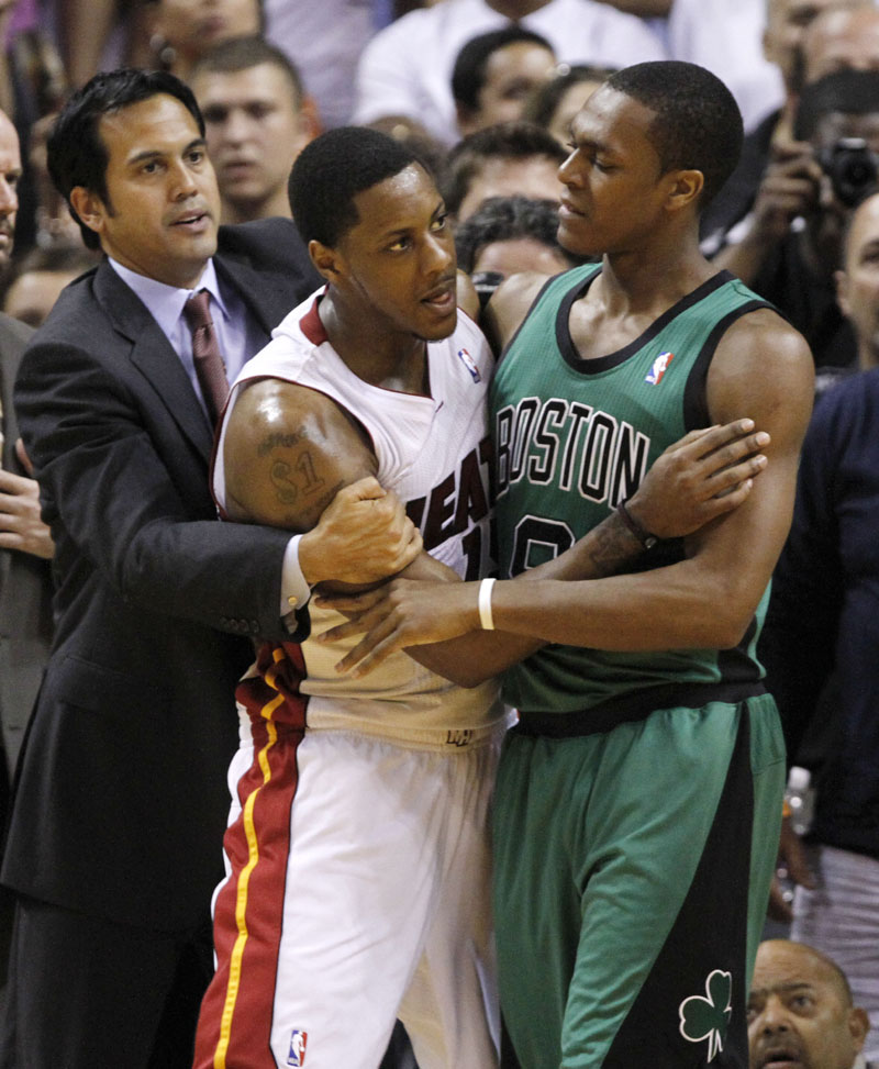 KEEPING THE PEACE: Miami Heat coach Erik Spoelstra, left, and Boston Celtics point guard Rajon Rondo, right, hold back Miami point guard Mario Chalmers during an altercation between the teams after Jermaine O’Neal fouled LeBron James in the second quarter Sunday evening in Miami. The Celtics lost 100-77.