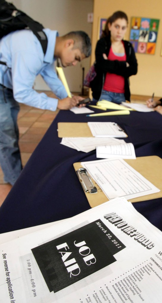 Job applicants fill out employment forms recently at a job fair in San Jose, Calif. The unemployment rate fell to a two-year low of 8.8 percent in March. Companies added workers at the fastest two-month pace since before the recession.