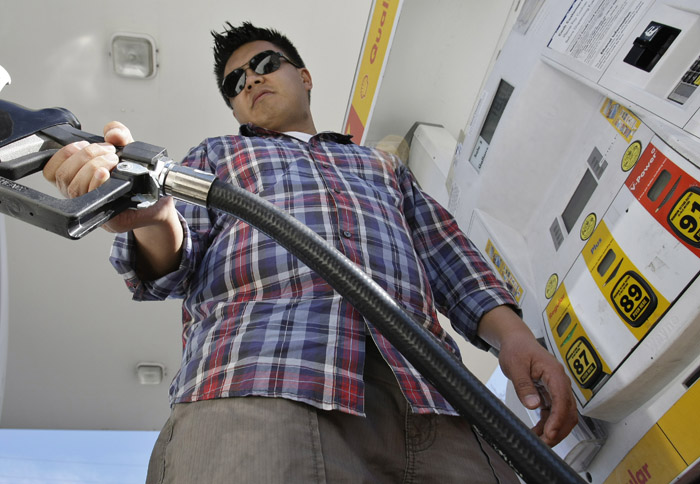 Daniel Dona pumps gas at a Shell gas station in Menlo Park, Calif., recently. With the price of gas above $3.50 a gallon in all but one state, there are signs that Americans are cutting back on driving, reversing a steady increase in demand for fuel as the economy improves.