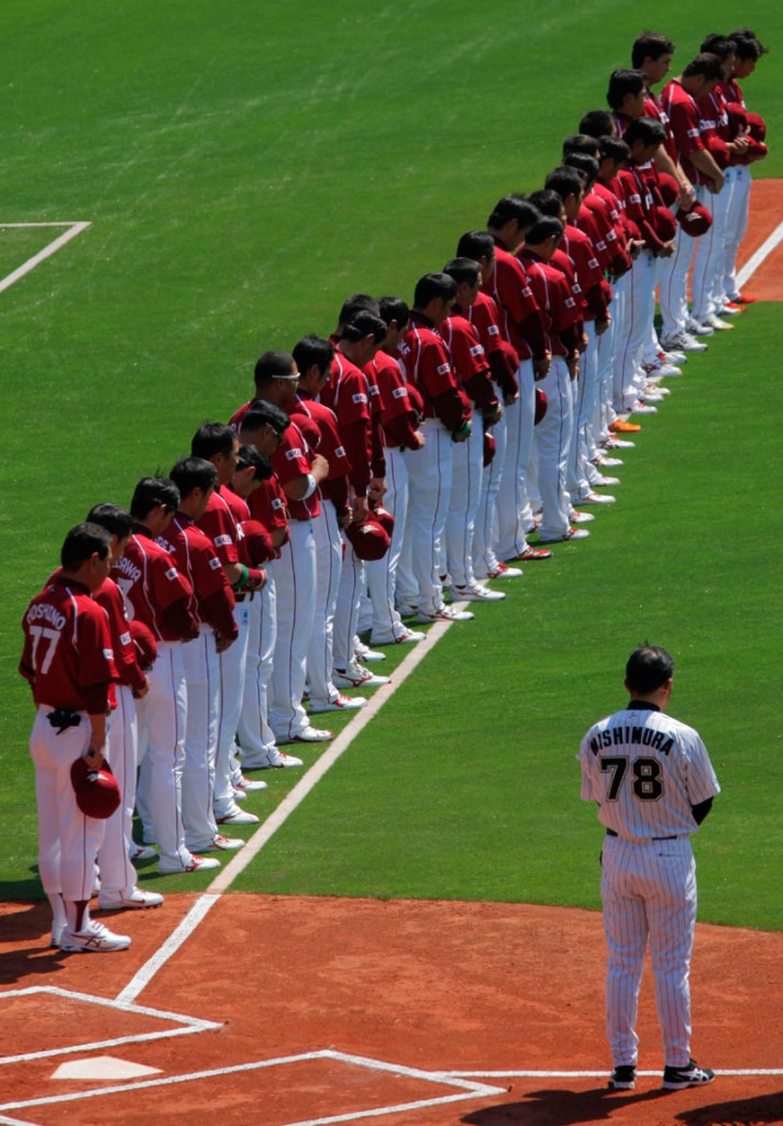 PAYING RESPECTS: Players of the Rakuten Golden Eagles, a Japanese professional baseball team based in Sendai, northeastern Japan, observe a moment of silence for victims of the March 11 earthquake and tsunami before their game against the Lotte Marrines on Tuesday in Chiba, near Tokyo. The 2011 pro baseball regular season kicked off Tuesday in Japan. 9.0 Magnitude Earthquake,Destru