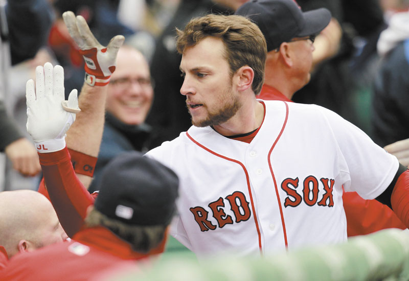 GIMME FIVE: Boston Red Sox shortstop Jed Lowrie celebrates after hitting a two-run home run in the second inning of the Red Sox’ 4-1 win over the Toronto Blue Jays on Saturday at Fenway Park in Boston.