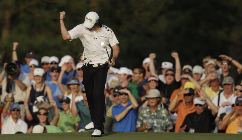 PRESSURE PUTT: Rory McIlroy celebrates after making a 25-foot birdie putt on the 17th hole during the third round of the Masters on Saturday in Augusta, Ga. He leads by four strokes.