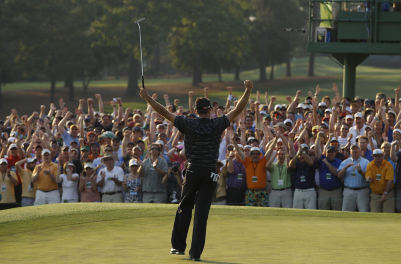 CLOSING THE DEAL: Charl Schwartzel celebrates after making a 20-foot birdie putt on the 18th hole during the final round of the Masters on Sunday in Augusta, Ga. The 26-year-old South African shot a 6-under 66 in the final round to win the green jacket by two strokes.