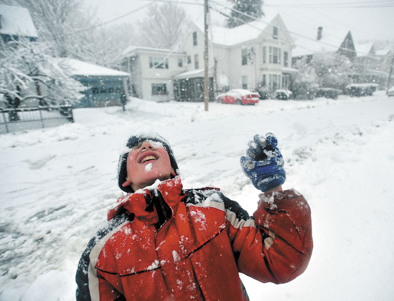 Joseph Libby-Cornette, 11, plays in the snow on Bellmont Avenue in Waterville on Friday. A nor’easter barrelled through central Maine, dropping close to a foot of new snow.
