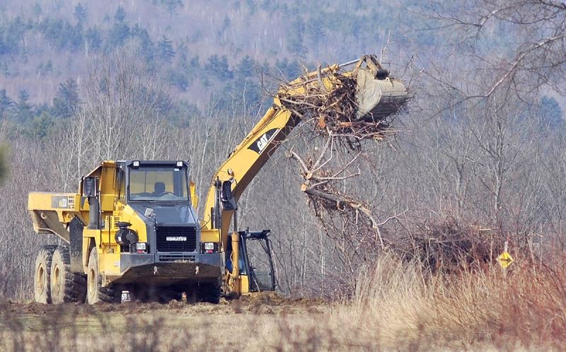Heavy equipment moves to cut down apple trees on Tuesday afternoon in Readfield at the Kents Hill Orchard. Officials said the trees were already dead or dying, and the site will become a vegetable farm.