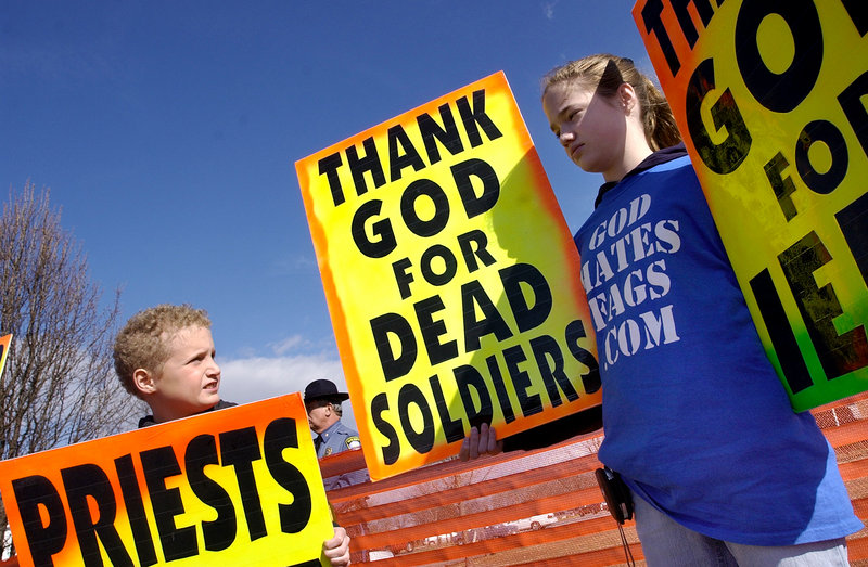 Westboro Baptist church members protest at a marine's funeral in this March 10, 2006, file photo. While current law places a 150-foot boundary around a military funeral service itself and 300 feet around access routes to the service, Snowe would up those lines to 300 feet and 500 feet. Snowe's bill also would impose criminal penalties on violators, including up to two years in prison.