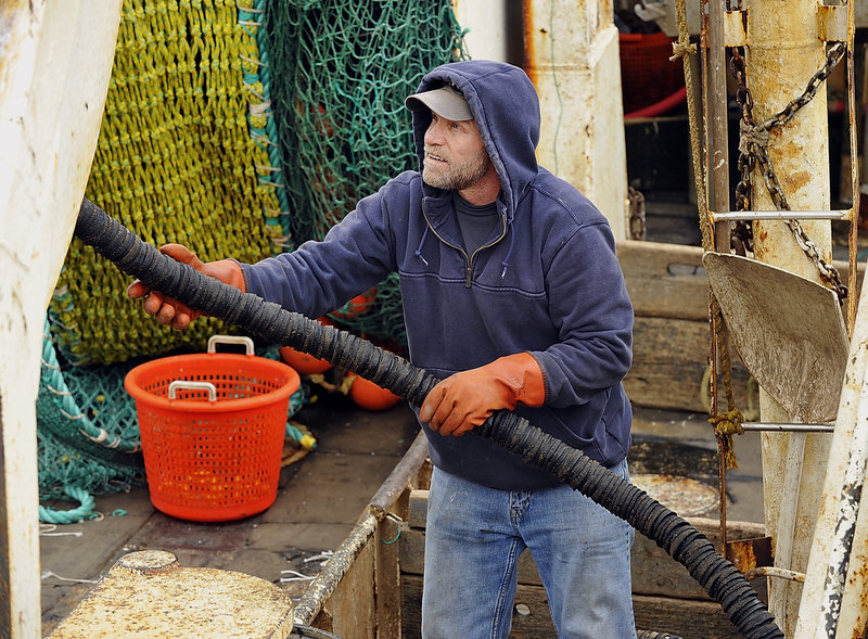 Alden Leeman, captain of the Jennifer and Emily, a ground fishing dragger fishing vessel, works on his net gear with crew on his boat while docked at the Portland Fish Exchange pier. Many fishermen say they are struggling under the new regulations that went into effect on May 1, but Leeman is one of the fishermen who support the new regulations and have seen increased profits.