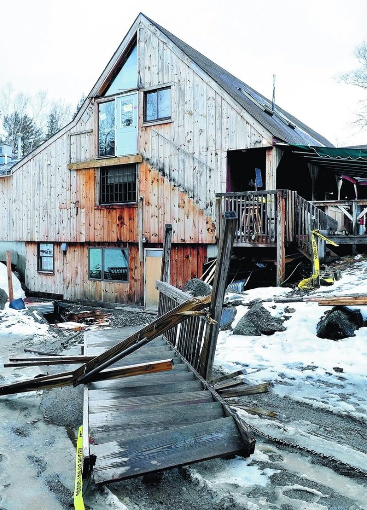 A set of stairs leading to a second floor doorway at the Rack bar and grill restaurant in Carrabassett Valley lies on the ground Sunday where it fell after 10 patrons assembled on the top landing around midnight on Saturday. Five people went to the hospital with injuries.