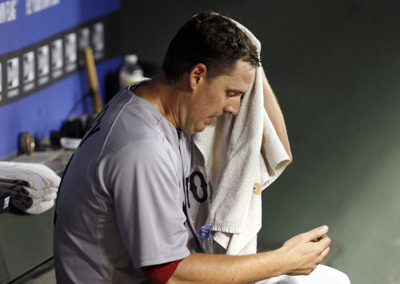 QUICK HOOK: Boston Red Sox pitcher John Lackey sits in the dugout after he was pulled from the game in the fourth inning against the Texas Rangers on Saturday night Arlington, Texas. Lackey gave up nine runs and 10 hits in 3 2/3 innings. Boston lost 12-5.