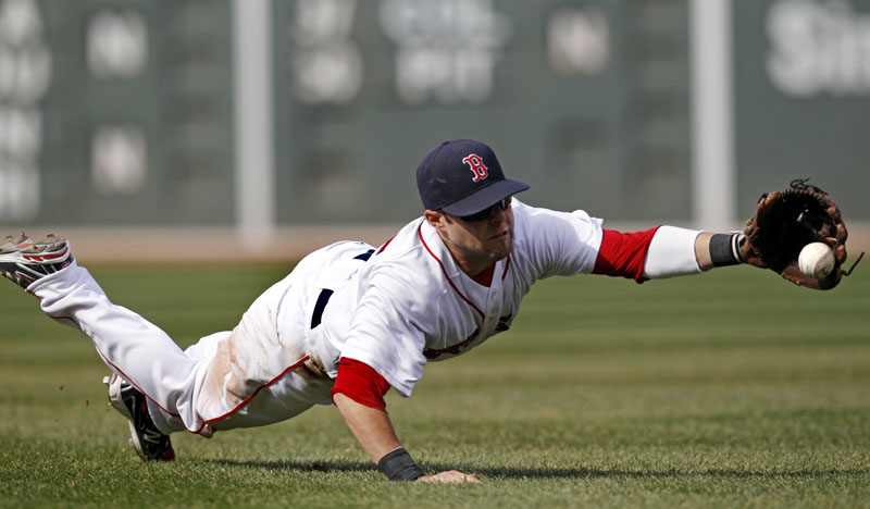 DIVING STOP: Boston Red Sox second baseman Dustin Pedroia dives and catches a sharp grounder hit by New York Yankees first baseman Mark Teixeira during the sixth inning Saturday at Fenway Park in Boston. Pedroia threw Teixeira out at first base, but the Red Sox lost 9-4.