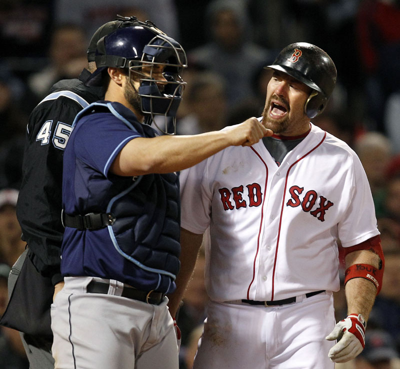CAUGHT LOOKING: Boston Red Sox third baseman Kevin Youkilis, right, argues a called third strike by umpire Jeff Nelson, left, as Tampa Bay Rays catcher Kelly Shoppach looks on during the sixth inning Tuesday night at Fenway Park in Boston.