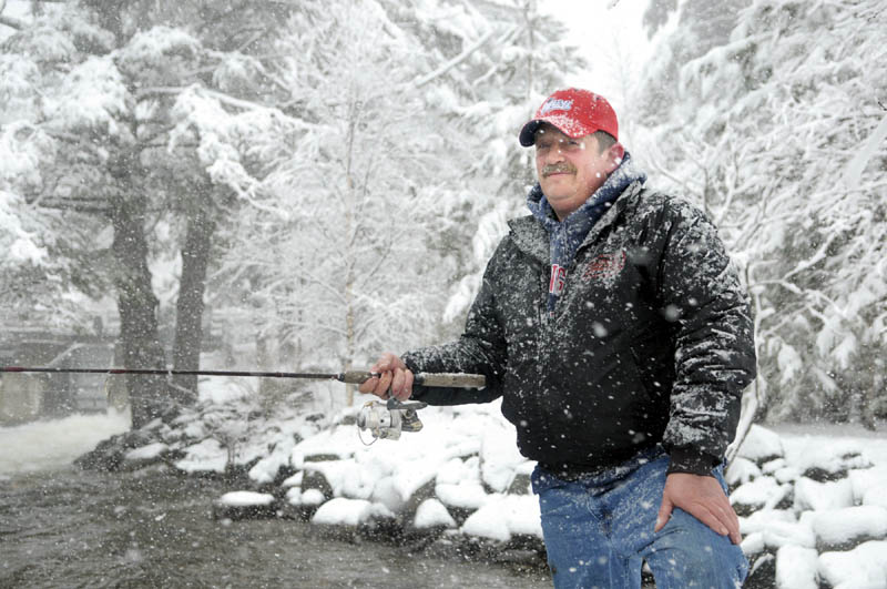 Paul Poulin, of Fairfield, fishes in Long Pond during the April Fools' Day snowstorm in Peninsula Park in Belgrade. He and his brother Mark Poulin said that they usually fish together on opening day of the open water fishing season, but that this was the worst weather they'd seen for a long time.