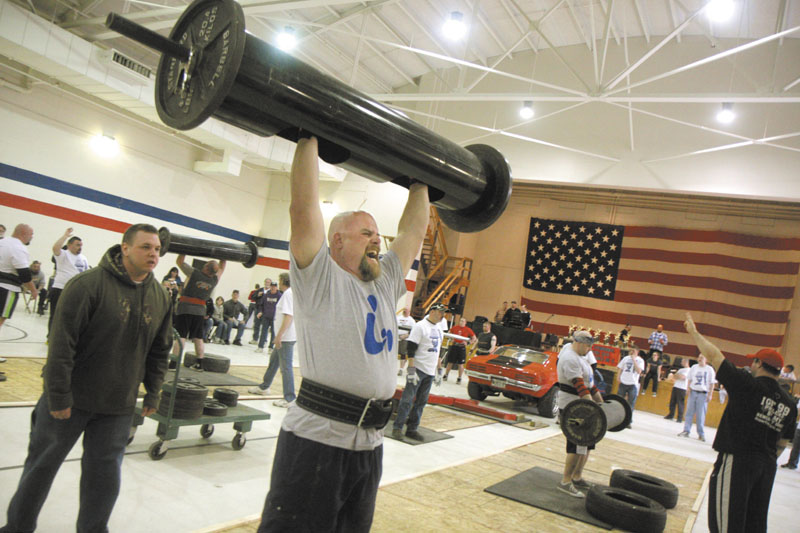 A STRONG MAN: Andrew Beckim of Vassalboro lifts 180 pounds while competing in the log press event at the fifth annual Central Maine Strongman competition at the Augusta Armory on Saturday.
