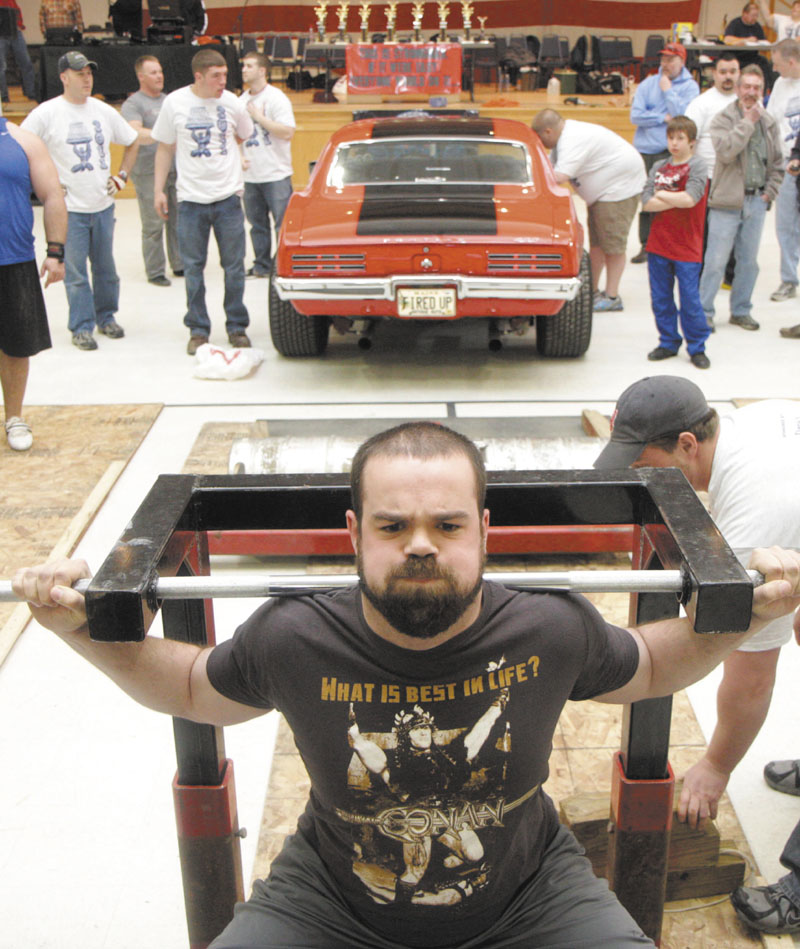 Photo by Jeff Pouland A CAR LIFT: Paul Sousa of Weymouth, Mass. practices his technique for the car squat event before it officially gets underway at the fifth annual Central Maine Strongman competition Saturday at the Augusta Armory.