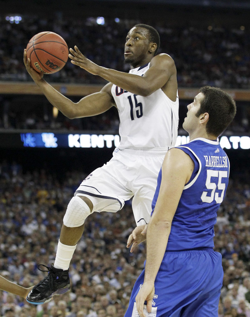 DRIVING FORCE: Connecticut's Kemba Walker shoots past Kentucky's Josh Harrellson defends during the second half of a Final Four game Saturday night in Houston. Walker scored a team-high 18 points as UConn won 56-55 to advance to Monday night's championship game against Butler.