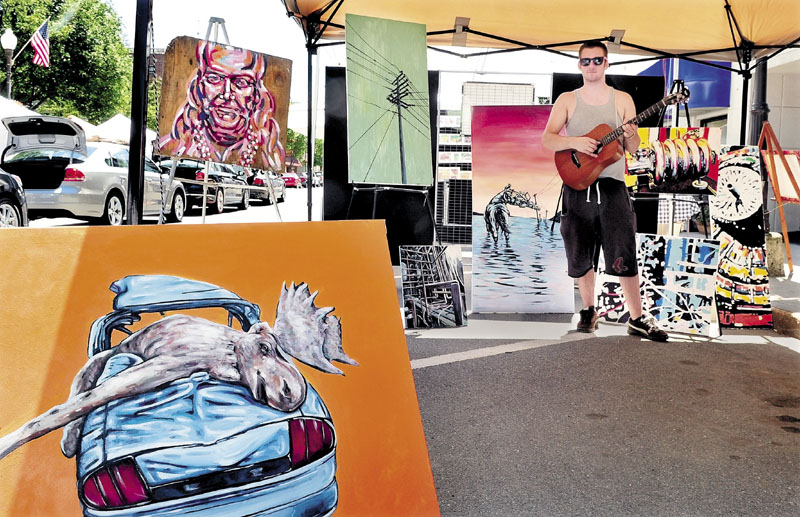 MULTI-TALENTED: Artist and musician Ryan Kohler diplays his talents Saturday during the Waterville Intown Arts Fest.