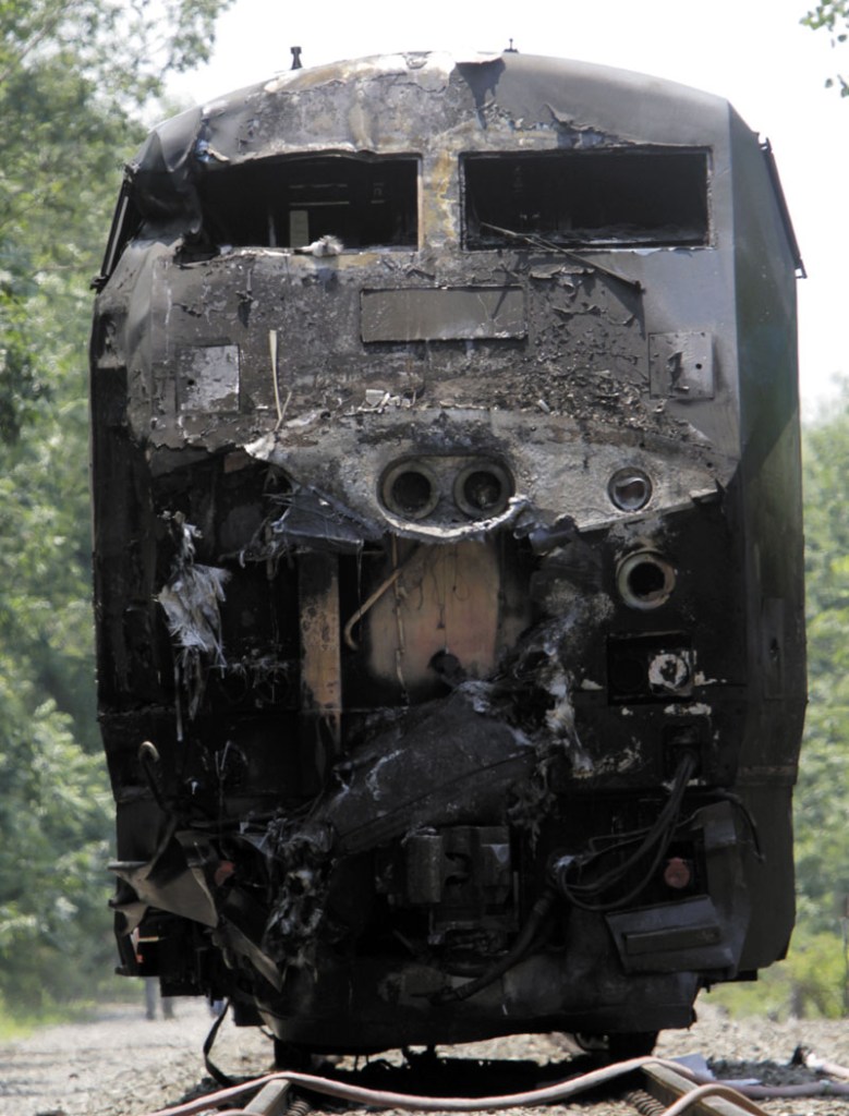 FATAL CRASH: The charred engine of the Amtrak train that collided into a tractor-trailer is seen Monday in North Berwick. Both were set on fire and the truck driver, identified by police as Peter Barnum of Farmington, N.H., was killed. The crash occurred about 11 a.m.