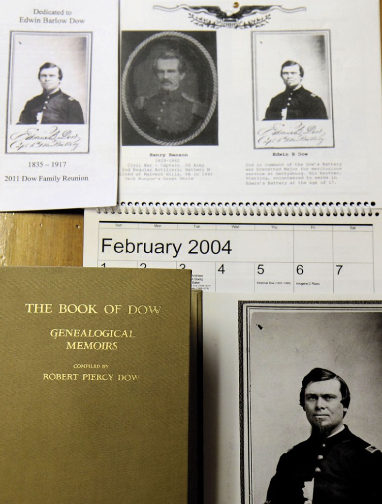 FAMILY MEMORABILIA: Family memorabilia including a calendar devoted to family relatives who fought in wars, a genealogical memoir of the Dow Family and photographs of Capt. Edwin Barlow Dow who led the 6th Maine Battery into action on the second day of the Battle of Gettysburg sit on a table at the home of Betty and John Dow of Cornville.