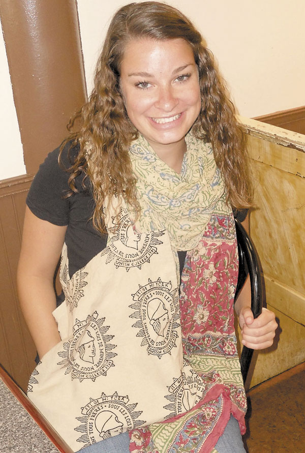 MAKING A DIFFERENCE: Emily LaCroix displays a Bagru Textiles scarf and a bag with Union College's logo.