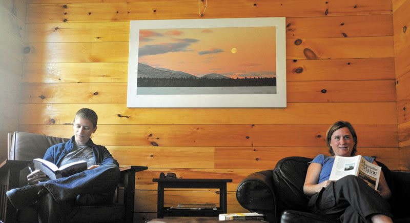 R&R: Jane Morris, left, and Meg MacDougal take advantage of the time before the dinner bell to catch up on some reading in one of the community rooms at the Flagstaff Lake Hut in Carrabassett Valley last week.