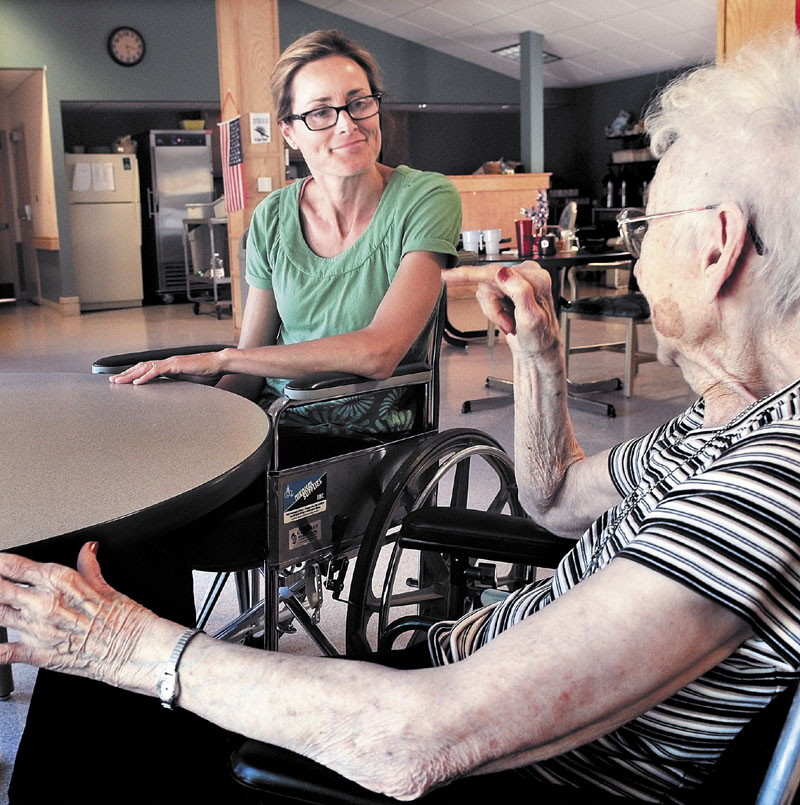 CAREGIVER: Graduate student Kara janes, left, speaks with Lakewood Continuing Care Center resident Martha Rogers on Tuesday. Janes is staying at the Waterville facility to gain experience from a resident's view for her career.