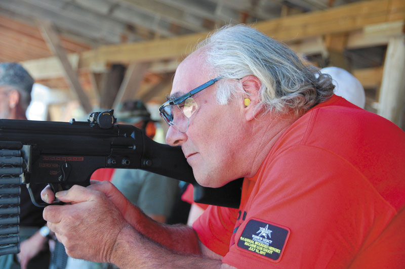 SHOOTING EVENT: Dwight Dodge, 56, of Paris, takes aim in the Warrior Legacy Foundation’s Wounded Heroes Machine Gun Shoot on Sunday in North Anson.