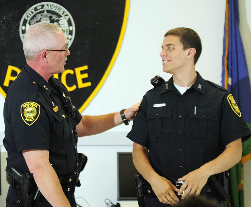 Augusta Police Chief Robert C. Gregoire, left, talks to his department's newest officer Anthony Drouin before he is sworn in during a ceremony on Friday in Augusta.