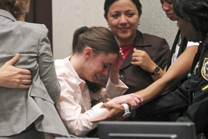 Casey Anthony, center, is overcome with emotion following her acquittal of murder charges on Tuesday.