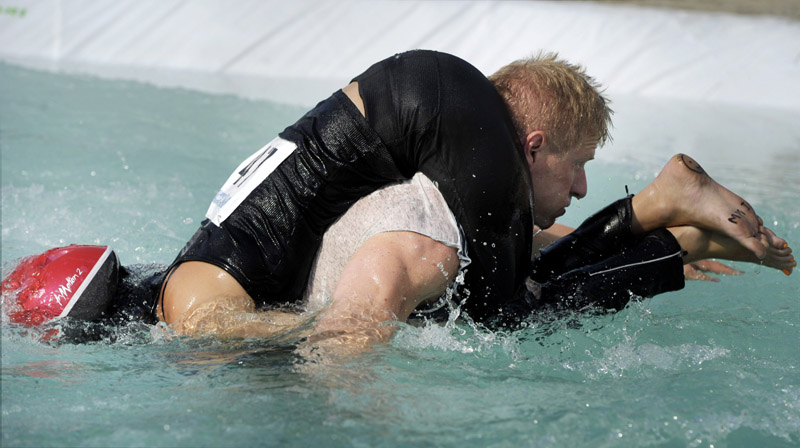 World champions Taisto Miettinen and Kristiina Haapanen of Finland compete during the Wife Carrying World Championship competition in Sonkajarvi, Finland, on July 2.