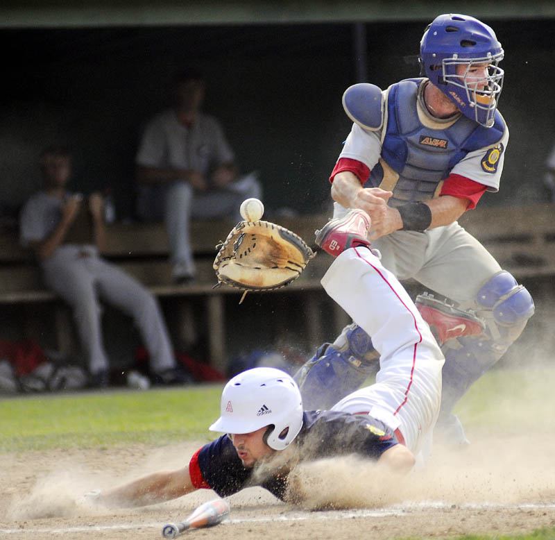 TOUGH SLIDE: Augusta’s Ryan Edwards knocks the glove and ball away from Gayton Post catcher Mekae Hyde while sliding into home Thursday during Augusta’s 21-11 win in the American Legion Baseball state tournament in Augusta.