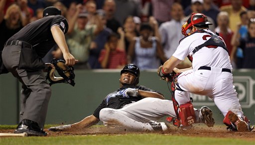 Toronto Blue Jays' Edwin Encarnacion, center, slides into home plate as Boston Red Sox catcher Jason Varitek, right, prepares to tag him out in the ninth inning Tuesday at Fenway Park, in Boston. Encarnacion was called out, ending the game and giving the Sox a 3-2 win.