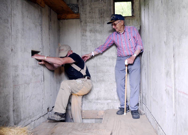 IT’S SAFE NOW: Donald Tuttle, 86, right, helps Roland Arno, 76, climb out of the bomb shelter at Arno’s home on Mount Vernon Avenue in Augusta. Tuttle built the shelter in the 1950s, but it’s scheduled to be demolished to make room for Augusta’s upcoming $17.3 million sewer line replacement.
