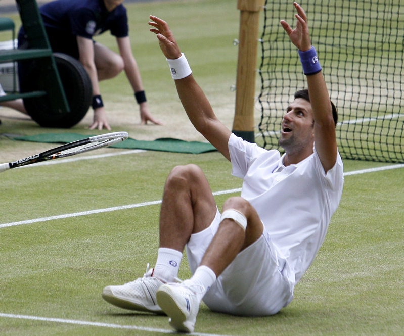 Novak Djokovic celebrates after defeating Rafael Nadal today in the men's singles final at the All England Lawn Tennis Championships at Wimbledon.