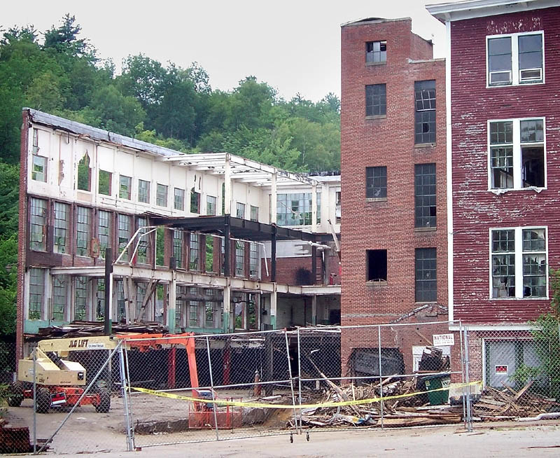 A DANGEROUS SITE: Police tape blocks the entrance to the former Forster Manufacturing Co. building complex Thursday on Depot Street in Wilton. The demolition site has been closed down amid reports of dangerous levels of airborne asbestos, according to Bill Coffin, director of the federal Occupational Safety and Health Administration in Maine.